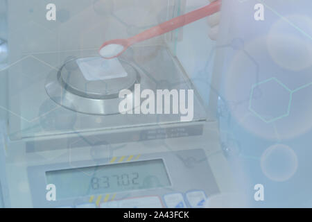 Weighting of ascorbic acid in chemical laboratory. Stock Photo
