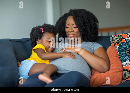 African American pregnant mother and her daughter. Stock Photo