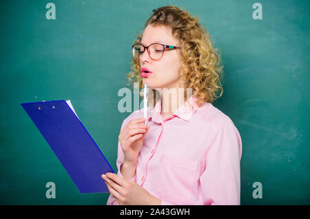 Tutor checking homework. Woman smart lady hold tablet documents. Read personal profile. Estimate essay of applicants. Literature teacher read composition. Read impressing resume. School project. Stock Photo