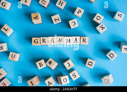 Wooden letters on blue background representing concept about education Stock Photo