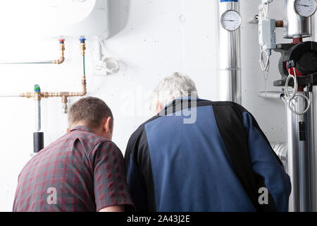 men at work in ac and heating room Stock Photo