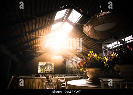 Interior of a rural restaurant for events elegantly decorated at sunset. Stock Photo