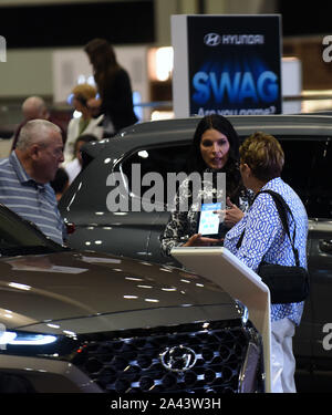 Orlando, Florida, USA. 21st Sep, 2019. A Hyundai product specialist speaks with attendees at the 2019 Central Florida International Auto Show at the Orange County Convention Center.Hyundai and Kia announced on October 11, 2019 that they have agreed to settle a class action lawsuit over engine fires by paying customers who purchased certain Hyundai and Kia models a total of $760 million. Credit: Paul Hennessy/SOPA Images/ZUMA Wire/Alamy Live News Stock Photo
