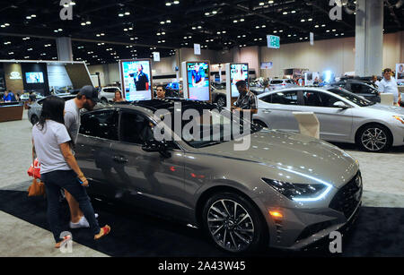Orlando, Florida, USA. 21st Sep, 2019. People look at a display of Hyundai vehicles during the 2019 Central Florida International Auto Show at the Orange County Convention Center.Hyundai and Kia announced on October 11, 2019 that they have agreed to settle a class action lawsuit over engine fires by paying customers who purchased certain Hyundai and Kia models a total of $760 million. Credit: Paul Hennessy/SOPA Images/ZUMA Wire/Alamy Live News Stock Photo