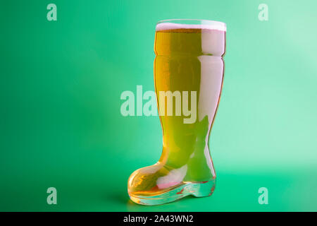 Beer in a boot beer glass in green background horizontal Stock Photo