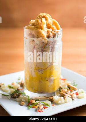Ceviche called leche de tigre - peruvian fresh fish in a glass. Stock Photo