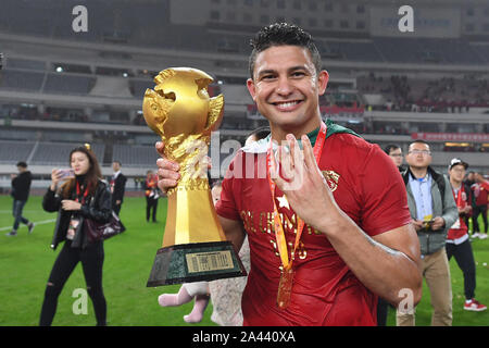 --FILE--Brazilian football player Elkeson de Oliveira Cardoso, or simply Elkeson celebrates his fourth championship of China Football Association Supe Stock Photo