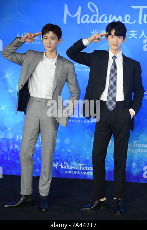 Chinese actor Bai Jingting, left, poses with a wax figure of him during an unveiling ceremony at the Madame Tussauds museum in Beijing, China, 20 Augu Stock Photo