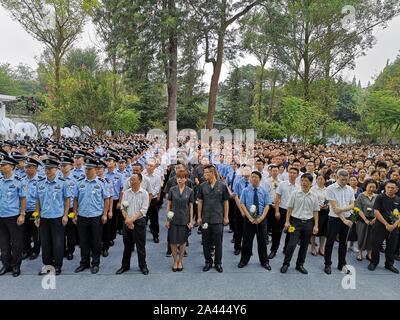Thousands of people spontaneously gather to attend the funeral of two scarificed policemen, Li Ke and Zhou Zhengliang, who died during the rescue oper Stock Photo