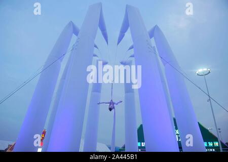 English highly experienced aerialist Amy Panter performs at the Golden Beech Beer City in Qingdao city, east China's Shandong province, 31 July 2019. Stock Photo