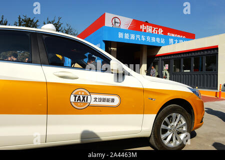 --FILE--A BAIC BJEV taxi is parked in a charging station in Beijing, China, 29 October 2016.   Beijing plans to have around 20,000 electric taxis by t Stock Photo