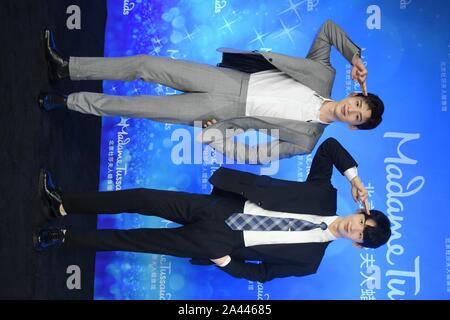 Chinese actor Bai Jingting, left, poses with a wax figure of him during an unveiling ceremony at the Madame Tussauds museum in Beijing, China, 20 Augu Stock Photo