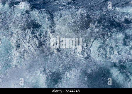 Aquatic background of sea surf waves splashing close up with clear blue green water and white foam Stock Photo