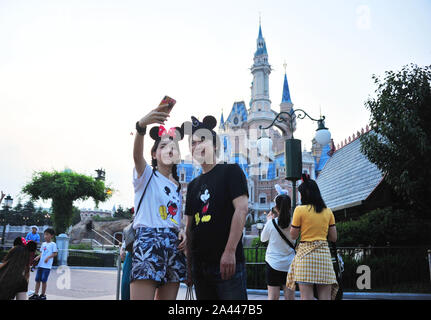 --FILE--Tourists enjoy themselves at Shanghai Disneyland in Shanghai, China, 21 August 2019.   The query raised recently related to the regulation set Stock Photo