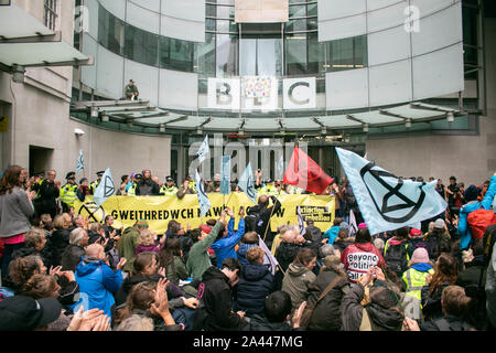 London, UK. 11th Oct, 2019. Climate activists from Extinction Rebellion who have climbed on the roof of BBC Broadcasting House as the building was being locked down preventing journalists from leaving. Extinction Rebellion have accused the British broadcasting service of bias and remaining silent over the issue of climate change. Credit: SOPA Images Limited/Alamy Live News Stock Photo