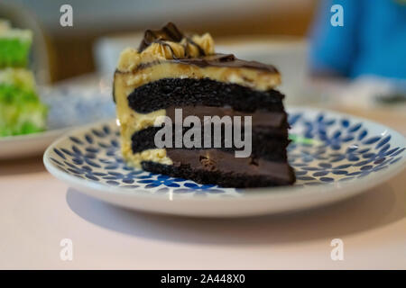 A slice of chocolate cake on the plate. Coffee cake tea time concept. Stock Photo