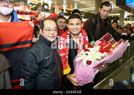 --FILE--Football fans welcome Brazilian football player Elkeson de Oliveira Cardoso, or simply Elkeson,front middle, at Shanghai international airport Stock Photo