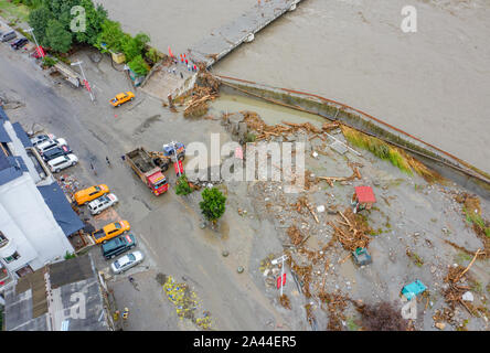 Residential buildings are roads are covered with stones and mud after hit by multiple mudslides triggered by heavy rainfall in Shuimo town, Wenchuan c Stock Photo
