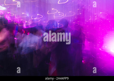 Dance floor at the concert filled with slow-dancing couples. motion blurred Stock Photo