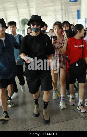 Chinese actor and singer Chen Kun, sometimes credited as Aloys Chen, middle black, arrives at the Beijing Capital International Airport after landing Stock Photo