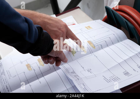 workmen and engineer working an planing on the job showing hands Stock Photo