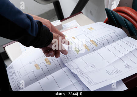 workmen and engineer working an planing on the job showing hands Stock Photo