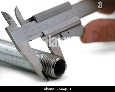 Precise measurement of a thread with a vernier caliper isolated on white background Stock Photo