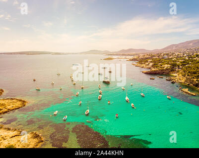 Incredible landscape. Yachts in the cove of turquoise sea, aerial drone view. Xinxell, Playa de Illetas, Palma de Mallorca, Balearic Islands. Popular Stock Photo