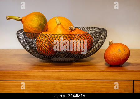 Autumn harvest, small pumpkins on the table Stock Photo