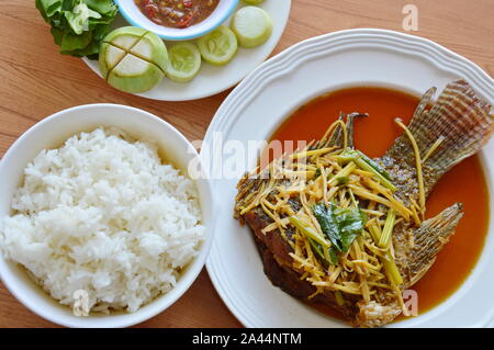 fried fish dressing ginger soy sauce eat with rice and spicy shrimp paste sauce Stock Photo