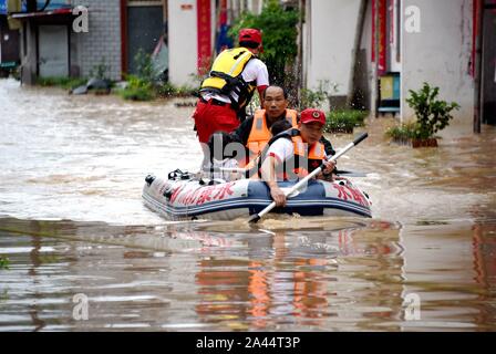 Chinese rescuers evacuate local residents in floodwater after heavy rains caused by Typhoon Lekima, the 9th typhoon of the year, in Qingkouyuan villag Stock Photo