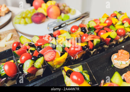 Different types of canapes on buffet table Stock Photo