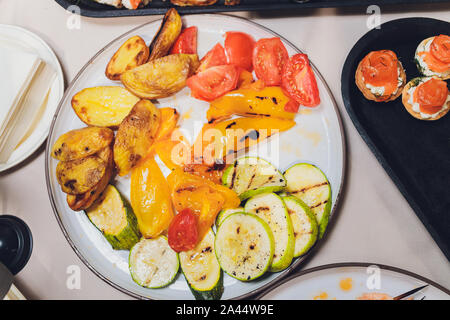Different types of canapes on buffet table Stock Photo