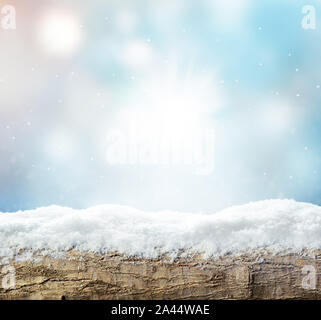 Winter background with snow and blur abstract lights. Empty wooden plank. Copyspace for text Stock Photo