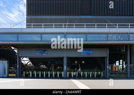 Melbourne, Australia - December 7, 2016: Southern Cross station platform entrance with pay, ticket gates and woman walking apst Stock Photo