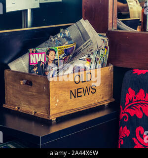 Gold Coast, Queensland/Australia - Feb 27, 2016: Wooden tray with text Old News on it and old magazines and newspapers. Concept of old news, obsolete Stock Photo