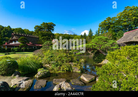 Oshino, Japan - September 2, 2016: Oshino Hakkai, Fuji Five Lakes. Japan countryside landscape of historic thatch roof farmhouses and pond with water Stock Photo