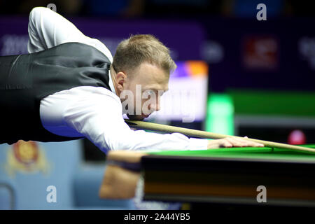 Judd Trump of England plays a shot to Tom Ford of England in their quarterfinal match during the 2019 World Snooker International Championship in Daqi Stock Photo