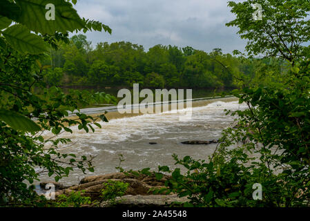 Small waterfall as water flows over dam on river in Great Falls National Park in spring. Stock Photo