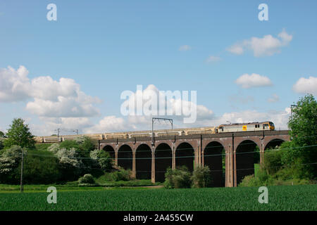 A class 92 electric locomotive number 92025 working a train of empty cart wagon over Sopers Viaduct at Cuffley on the 23rd May 2006. Stock Photo