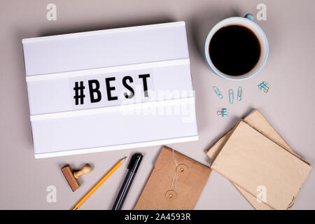 Hashtag with word Best. White lightbox on a gray office desk. Social media, marketing and motivation Stock Photo
