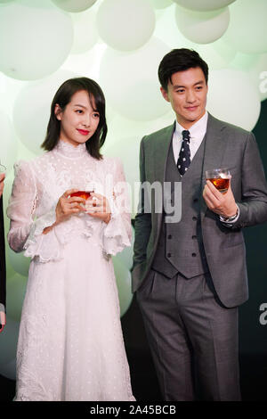 Chinese singer and actress Victoria Song or Song Qian, left, and actor Zhou Yiwei attend a promotional event for Hennessy in Hangzhou city, east China Stock Photo