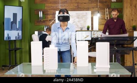 Female architects exploring virtual reality projects of business buildings. Future of architecture and building industry. Stock Photo