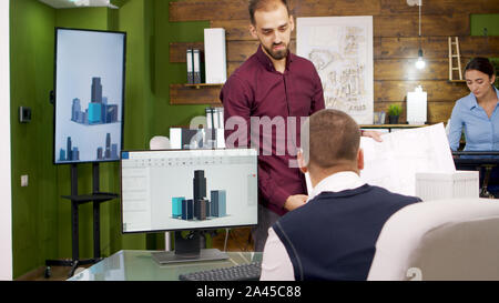 Bearded architects working on a new house development project. 3d Building model. Stock Photo