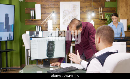 Construction engineers working on a heating turbine for business buildings. Computer screen. Stock Photo
