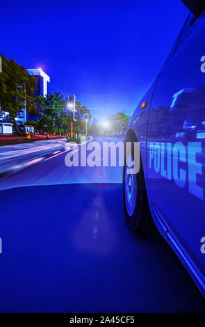 Police Sedan car speeding in the night through traffic lights, motion blur, Gaborone, Botswana, Stock Photo