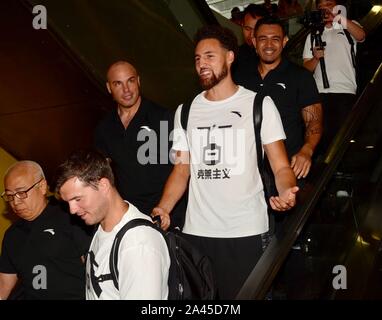 American professional basketball player Klay Thompson, middle, is surrounded by enthusiastic fans when arriving at Shanghai Pudong International Airpo Stock Photo