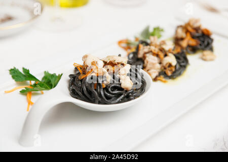 Black pasta with seafood, close-up