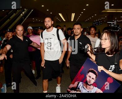 American professional basketball player Klay Thompson, middle, is surrounded by enthusiastic fans when arriving at Shanghai Pudong International Airpo Stock Photo