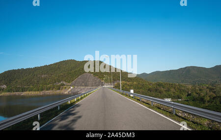 Safety steel barrier on freeway bridge designed to prevent the exit of the vehicle from the curb or bridge. Stock Photo